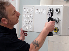 Engineer checking gas flow on theatre pendant medical gas maintenance